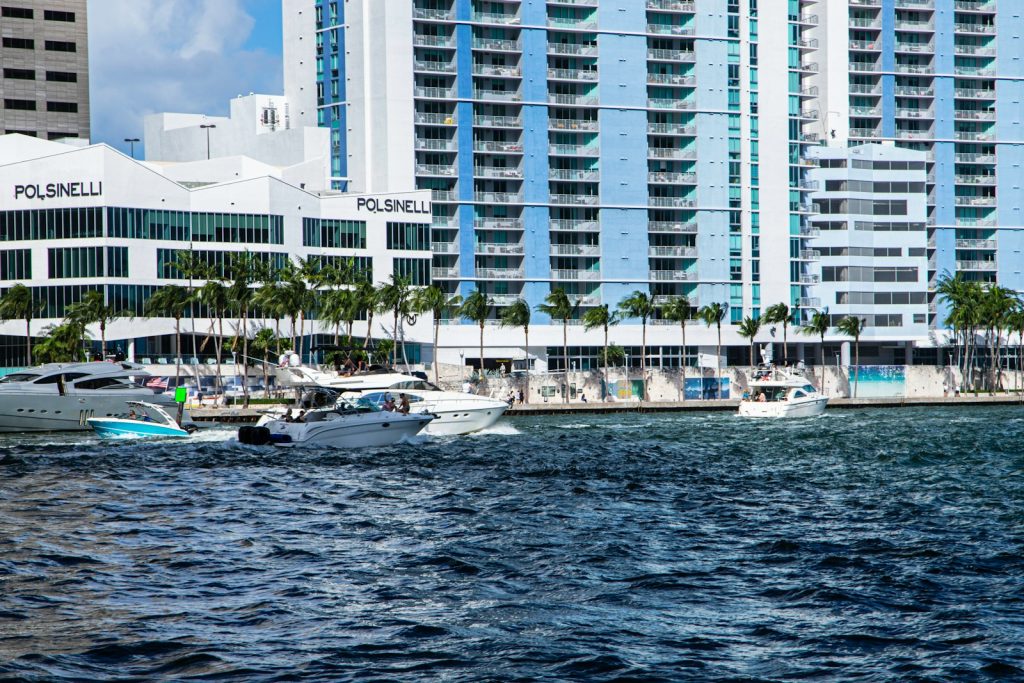 Modern Buildings And Boats Sit By The Water.